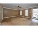 Living room with multiple windows and access to a door at 82 Paddington Sw Dr, Concord, NC 28025