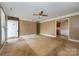 Open living room space with a ceiling fan and access to kitchen at 82 Paddington Sw Dr, Concord, NC 28025