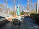 Backyard patio area with table, chairs, and a wishing well at 925 Belmorrow Dr, Charlotte, NC 28214