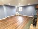 Spacious finished basement with hardwood flooring, a window, and ample lighting at 925 Belmorrow Dr, Charlotte, NC 28214