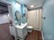 Stylish bathroom featuring blue walls, modern fixtures, and walk-in shower at 925 Belmorrow Dr, Charlotte, NC 28214