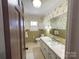 Well-lit bathroom with a sink, toilet, and decorative wallpaper at 925 Belmorrow Dr, Charlotte, NC 28214