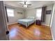 Cozy bedroom featuring hardwood floors, a comfortable bed, and natural light from two windows at 925 Belmorrow Dr, Charlotte, NC 28214