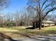 Brick home with driveway and mature trees at 925 Belmorrow Dr, Charlotte, NC 28214