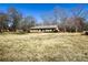 Lovely one-story brick home with a long, gabled roof and manicured green bushes at 925 Belmorrow Dr, Charlotte, NC 28214