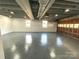 Finished garage with sealed floor, windows, and overhead lighting at 925 Belmorrow Dr, Charlotte, NC 28214