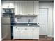 Basement kitchenette with white cabinets, subway tile backsplash, and stainless steel appliances at 925 Belmorrow Dr, Charlotte, NC 28214