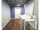 Bright laundry area with appliances, utility sink, and wood-look flooring at 925 Belmorrow Dr, Charlotte, NC 28214