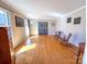 Bright living room with hardwood floors, neutral walls and front-facing windows at 925 Belmorrow Dr, Charlotte, NC 28214