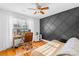 Stylish bedroom with hardwood floors, striking accent wall, and lots of natural light at 10105 Bon Meade Ln, Cornelius, NC 28031