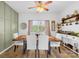 Elegant dining room with a modern light fixture, wainscoting, and seating for six at 10105 Bon Meade Ln, Cornelius, NC 28031