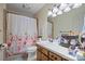 Well-lit bathroom with a floral shower curtain and functional vanity at 102 Brandywine Ne Dr # Q4, Conover, NC 28613