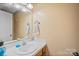 Simple bathroom featuring a single sink vanity, a large mirror, and neutral tones at 102 Brandywine Ne Dr # Q4, Conover, NC 28613