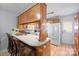 Functional kitchen featuring a breakfast bar, white appliances, and wood cabinetry at 102 Brandywine Ne Dr # Q4, Conover, NC 28613