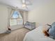 Bright bedroom with a crib, ceiling fan and large window allowing natural light at 108 Avaclaire Way, Indian Trail, NC 28079