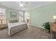 Bright bedroom with an ensuite bathroom, neutral color scheme, and a ceiling fan at 108 Avaclaire Way, Indian Trail, NC 28079