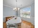 Dining area featuring a large window, white trim, and chandelier providing bright, natural light at 108 Avaclaire Way, Indian Trail, NC 28079