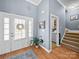 Inviting entryway with a neutral-toned rug, stairs, a plant, and a doorway to another room at 108 Avaclaire Way, Indian Trail, NC 28079