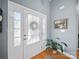 Bright entryway with a patterned glass door, wooden floors, and a decorative plant at 108 Avaclaire Way, Indian Trail, NC 28079