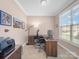 Home office setup with desk, chair, and large window at 108 Avaclaire Way, Indian Trail, NC 28079