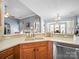 Kitchen sink with stainless steel dishwasher, light countertops, and open view into the living area at 108 Avaclaire Way, Indian Trail, NC 28079