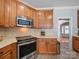 Kitchen with stainless steel oven and microwave, tile backsplash, and wood cabinets at 108 Avaclaire Way, Indian Trail, NC 28079