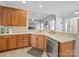 Kitchen with tile flooring, stainless steel appliances, and ample counter space, open to living room at 108 Avaclaire Way, Indian Trail, NC 28079