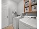 Laundry room with modern washer and dryer and storage cabinets at 108 Avaclaire Way, Indian Trail, NC 28079