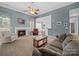 Open concept living room with fireplace, sofas, view into kitchen, and neutral colors at 108 Avaclaire Way, Indian Trail, NC 28079