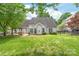 A well-maintained backyard featuring a patio with a pergola and a grassy area, surrounded by lush greenery and fencing at 111 Harris Farm Rd, Mooresville, NC 28115