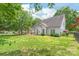 The property features a spacious, green backyard with mature trees and a black metal fence, offering privacy and outdoor enjoyment at 111 Harris Farm Rd, Mooresville, NC 28115