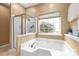 Bright primary bath features a shower, soaking tub and a large window to let the light in at 111 Harris Farm Rd, Mooresville, NC 28115