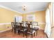 Formal dining room with seating for eight features a golden chandelier and lovely place settings at 111 Harris Farm Rd, Mooresville, NC 28115