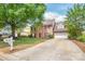 Two-story brick home with a well-maintained lawn, mature trees, and a driveway, showcasing suburban charm and inviting curb appeal at 111 Harris Farm Rd, Mooresville, NC 28115