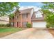 Two-story brick home with a two-car garage, well-manicured lawn, and mature trees, offering classic curb appeal and ample space at 111 Harris Farm Rd, Mooresville, NC 28115