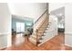 Inviting foyer with hardwood floors, a staircase, and an open view to the living room at 111 Harris Farm Rd, Mooresville, NC 28115