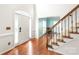 Bright entryway featuring hardwood floors, a staircase, and a view into the adjacent living space at 111 Harris Farm Rd, Mooresville, NC 28115