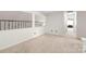 Bright and airy landing area with neutral carpeting, offering a versatile space in the home at 111 Harris Farm Rd, Mooresville, NC 28115