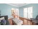 Inviting living room features a light blue wall color, wood flooring, and natural lighting at 111 Harris Farm Rd, Mooresville, NC 28115