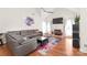 Open living room featuring a vaulted ceiling, fireplace, and hardwood floors at 111 Harris Farm Rd, Mooresville, NC 28115