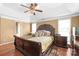 Bright main bedroom features a tray ceiling, hardwood floors, and elegant furnishings at 111 Harris Farm Rd, Mooresville, NC 28115