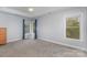 Bright bedroom with plush carpeting, tray ceiling, and natural light from two large windows at 1120 Millwright Ln, Matthews, NC 28104