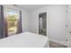 Small bedroom with large window, cozy bed, and ensuite bathroom at 1120 Millwright Ln, Matthews, NC 28104