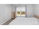 Simple bedroom with large window, double door closet, and natural light at 1120 Millwright Ln, Matthews, NC 28104