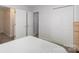 Standard bedroom layout with white doors, plush carpeting and view from a small window at 1120 Millwright Ln, Matthews, NC 28104