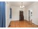 Dining room with wood floors, chandelier, and a view of the kitchen pantry and shelves at 1120 Millwright Ln, Matthews, NC 28104