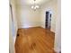 Dining room with hardwood floors, chandelier, and a pantry with pull out shelves at 1120 Millwright Ln, Matthews, NC 28104