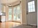 Bright dining area with hardwood floors, bay window, and access to a side door at 1120 Millwright Ln, Matthews, NC 28104