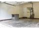 Spacious garage with a functional workbench, water heater, and access door at 1120 Millwright Ln, Matthews, NC 28104