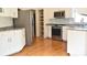 Modern kitchen with stainless steel appliances, granite countertops, and pantry with pull out shelves at 1120 Millwright Ln, Matthews, NC 28104